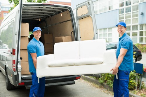 Professional furniture pick-up service removing a sofa in Brompton