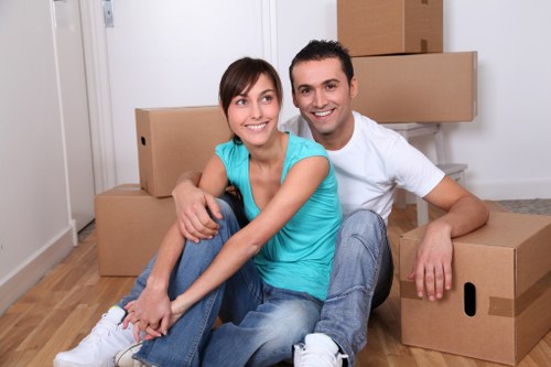 Professional team handling furniture removal in a Brompton flat with narrow access