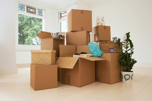Professional movers handling boxed office items during a Brompton relocation
